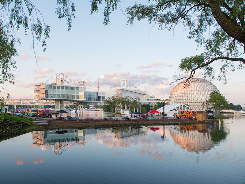 Cinesphere and Pods across the water. Reflection of the structures in the water.