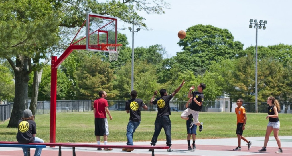 A picture of people playing basketball outside